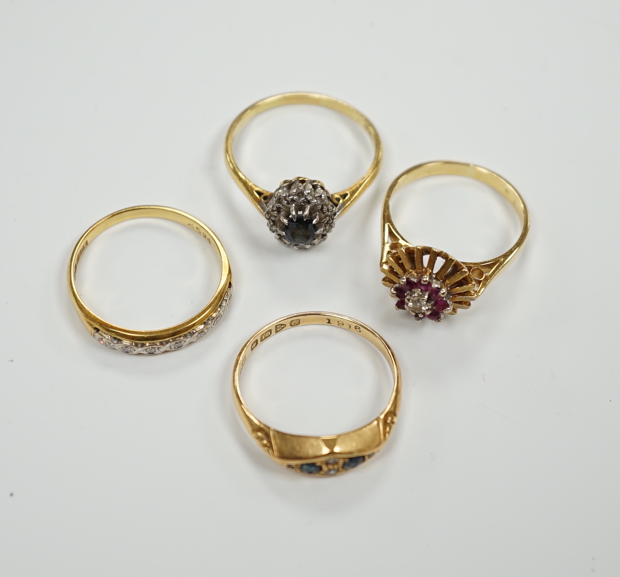 Four assorted Edwardian and later 18ct and gem set rings, including sapphire and diamond chip, size O, gross weight 12.1 grams.